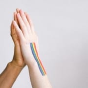 hand with gay pride body paint giving a high five 4557459