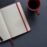 notebook and pen beside red mug on gray surface 3774057
